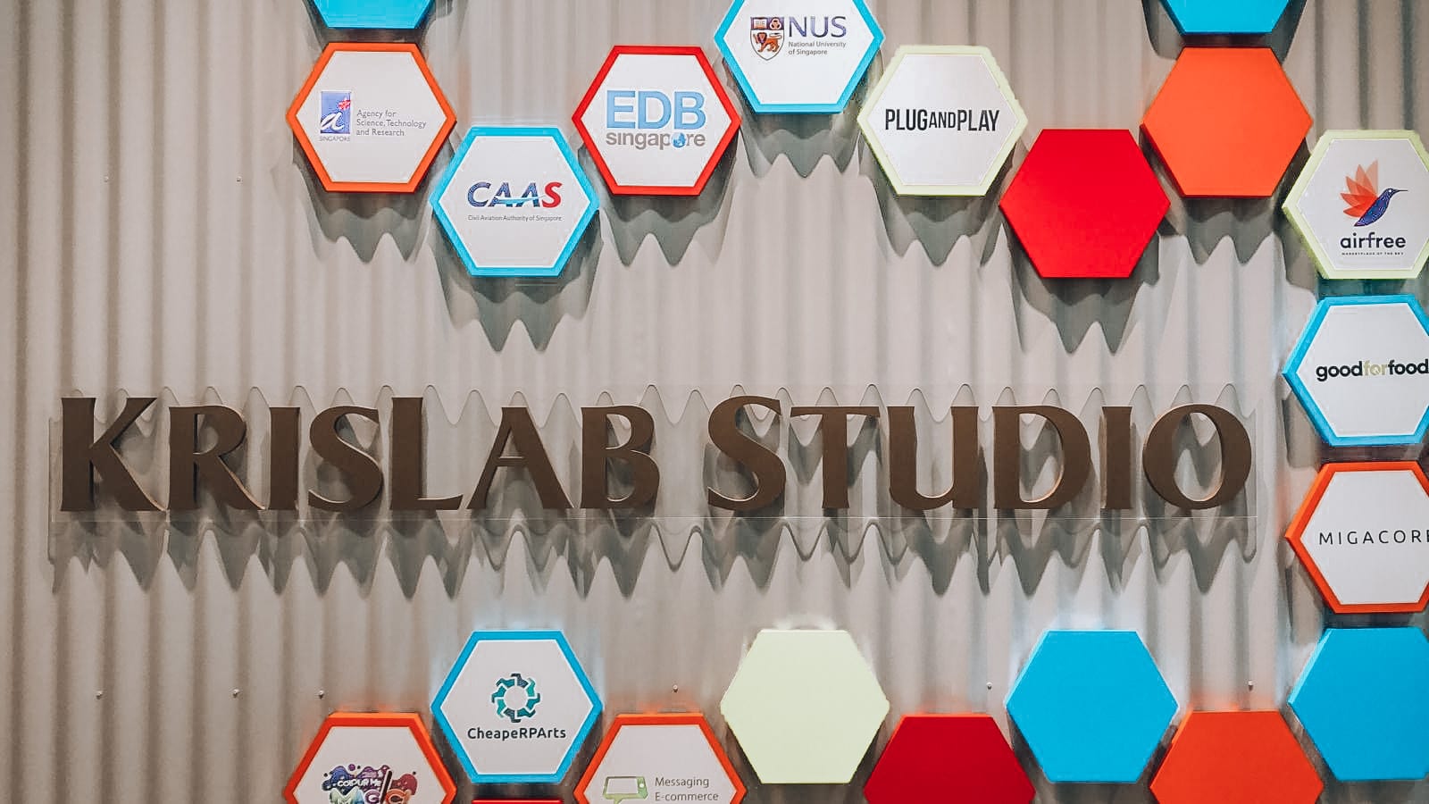 KrisLab Studio acrylic lettering on a hexagon wall — Acrylic Signage by Garrison Productions, Singapore