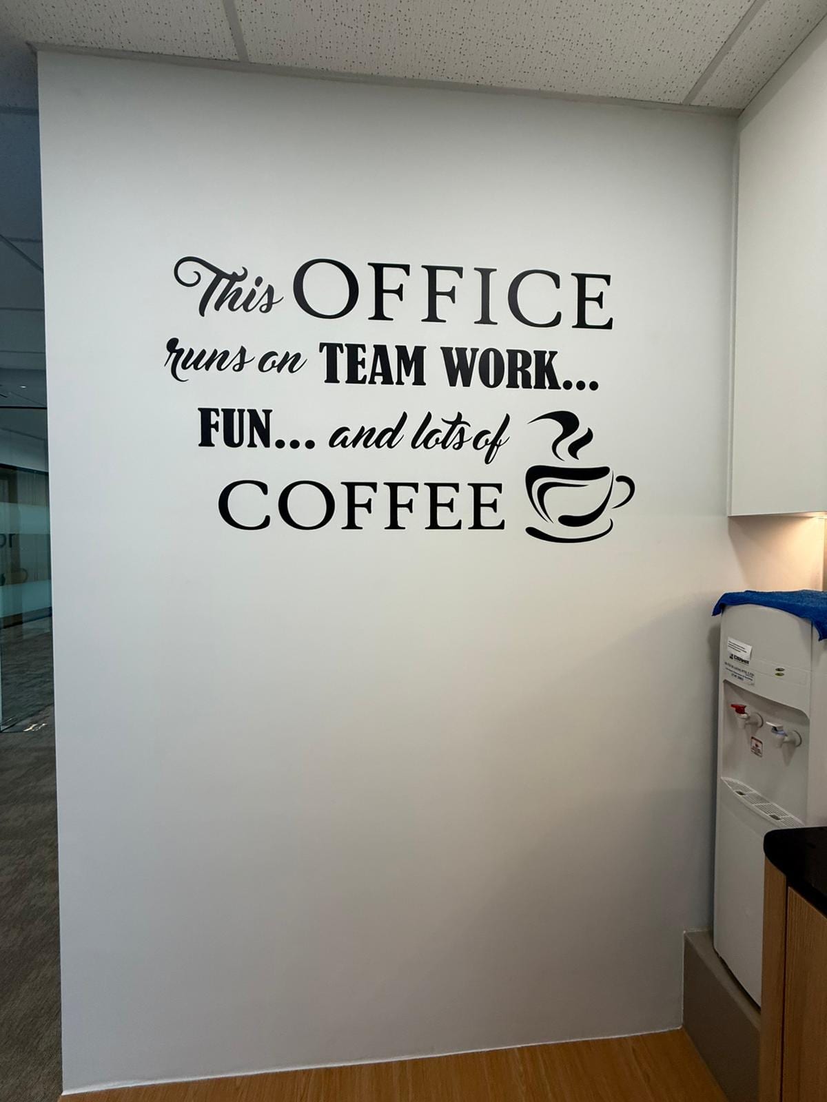 "This office runs on teamwork, fun and coffee" die-cut wall quote — Die Cut Stickers by Garrison Productions, Singapore