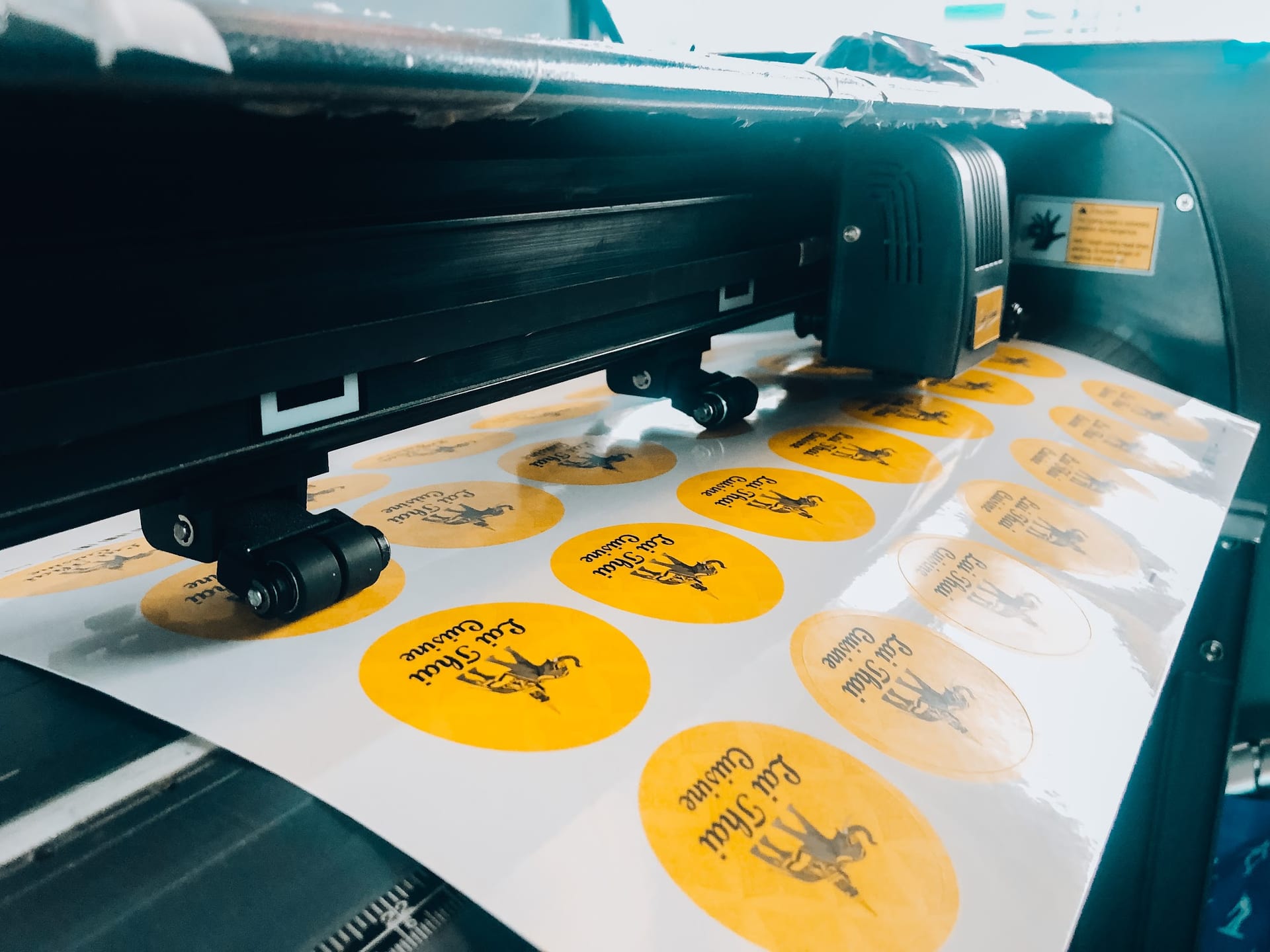 Die-cut stickers being cut on a plotter machine — Die Cut Stickers by Garrison Productions, Singapore