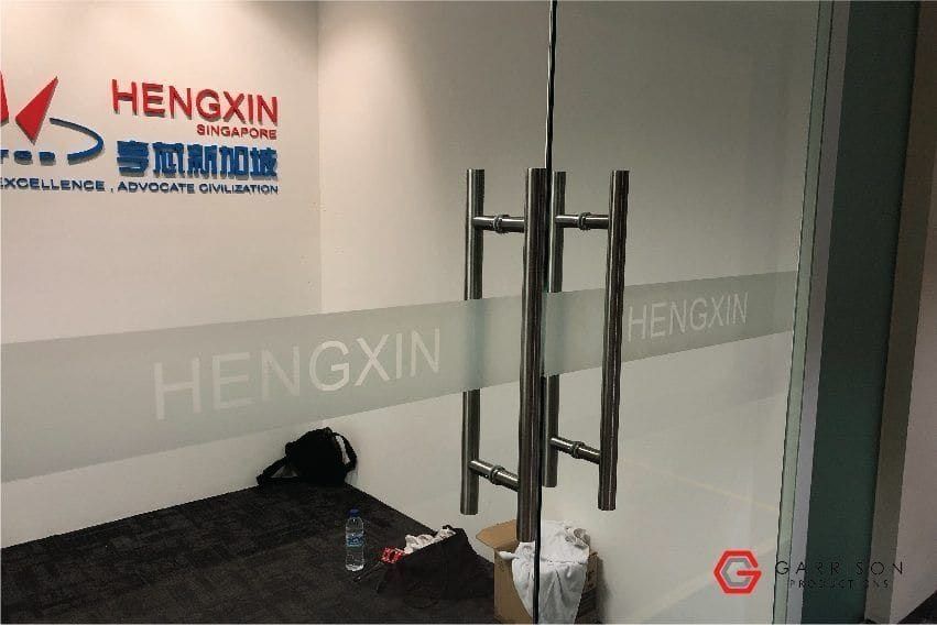 Hengxin logo frosted film on glass doors — frosted sticker for glass door in Singapore by Garrison Productions