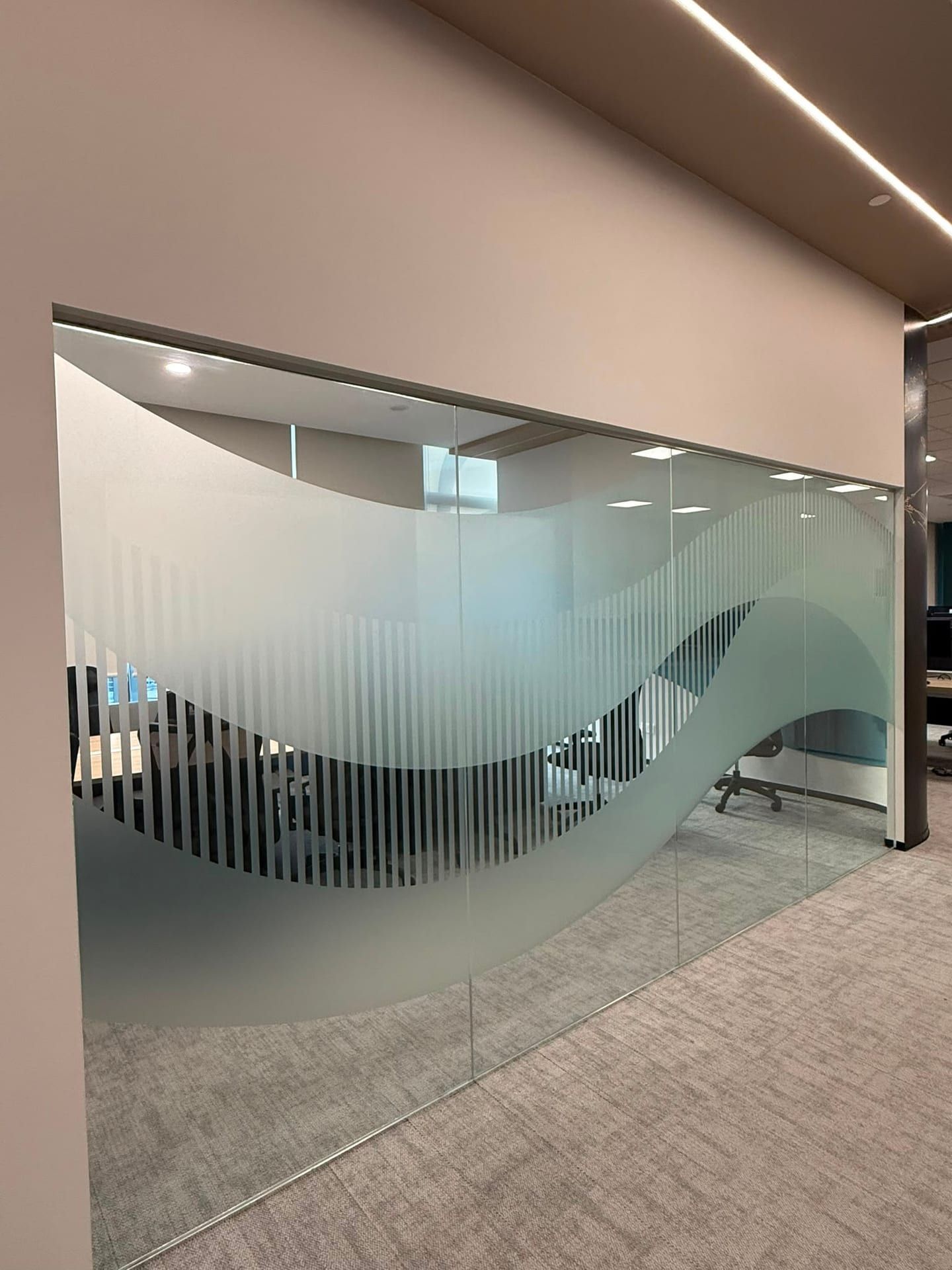 Wave-pattern frosted film on a curved glass wall — frosted sticker in Singapore by Garrison Productions