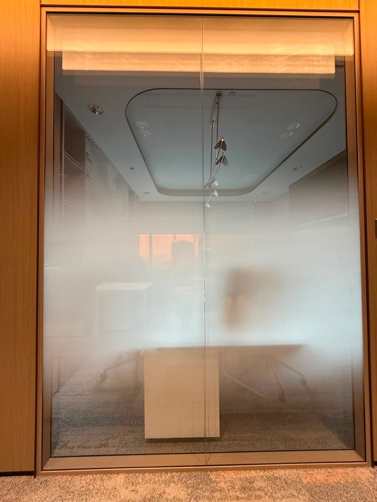 Gradient frosted film on a lit glass room — frosted glass sticker design in Singapore by Garrison Productions