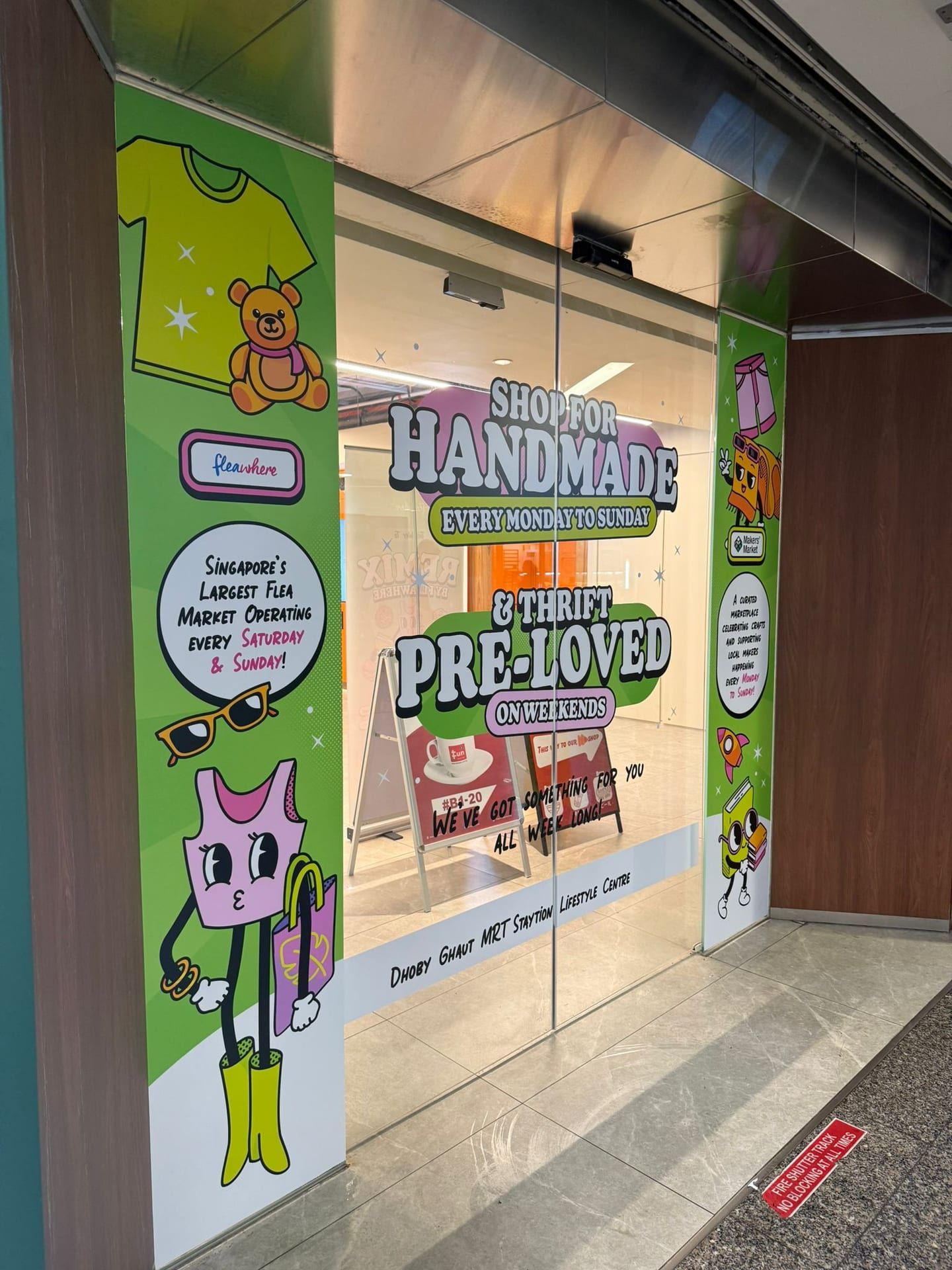 "Handmade, pre-loved" glass stickers on a shop entrance — glass stickers for windows in Singapore by Garrison Productions