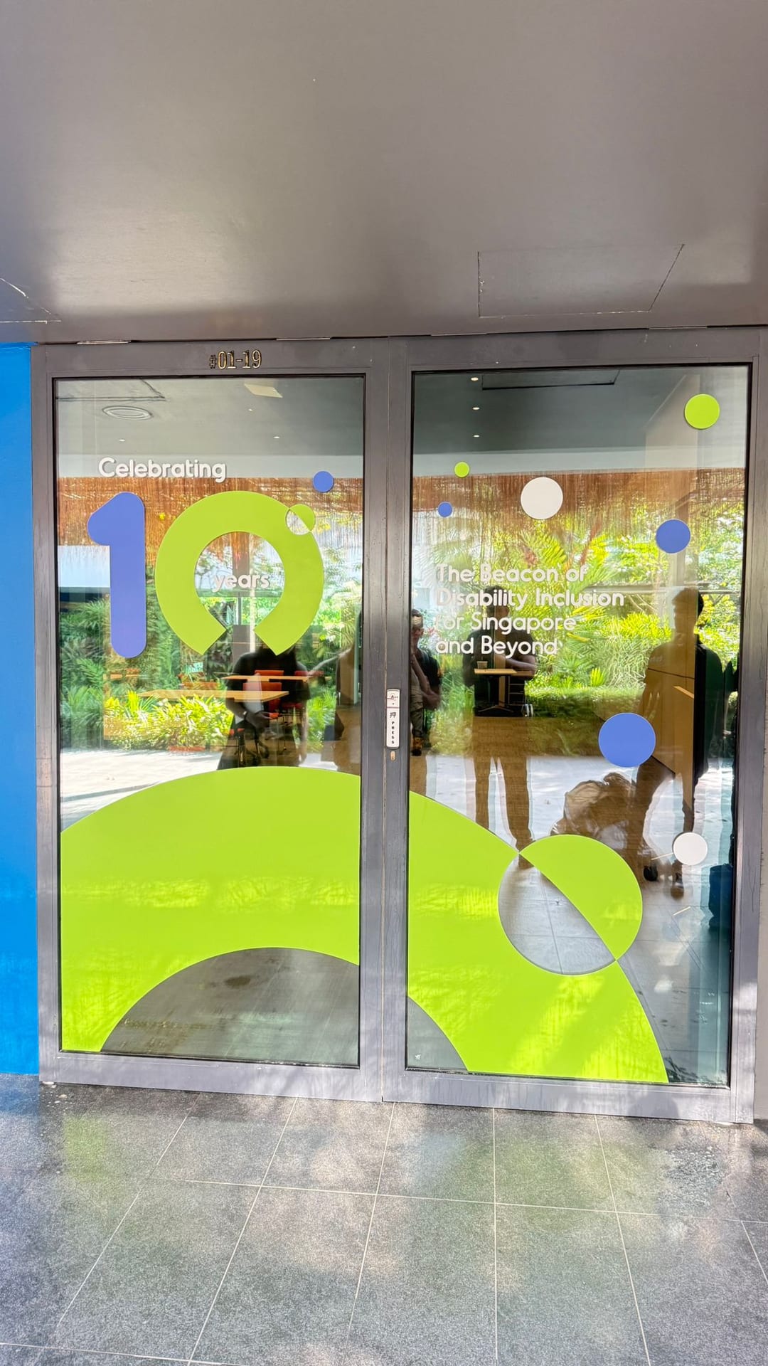 Green and yellow shape glass stickers on office doors — Glass Stickers by Garrison Productions, Singapore