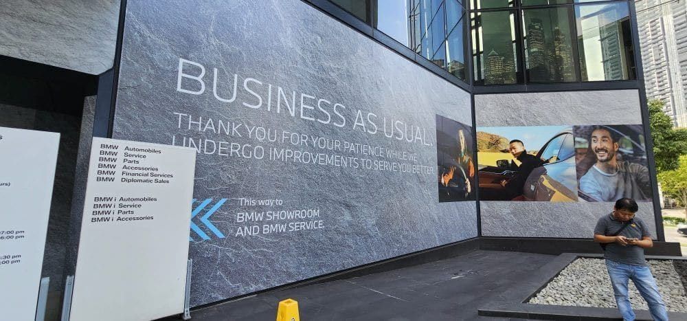 "Business as usual" showroom hoarding with car photos — Hoarding Sticker Printing by Garrison Productions, Singapore