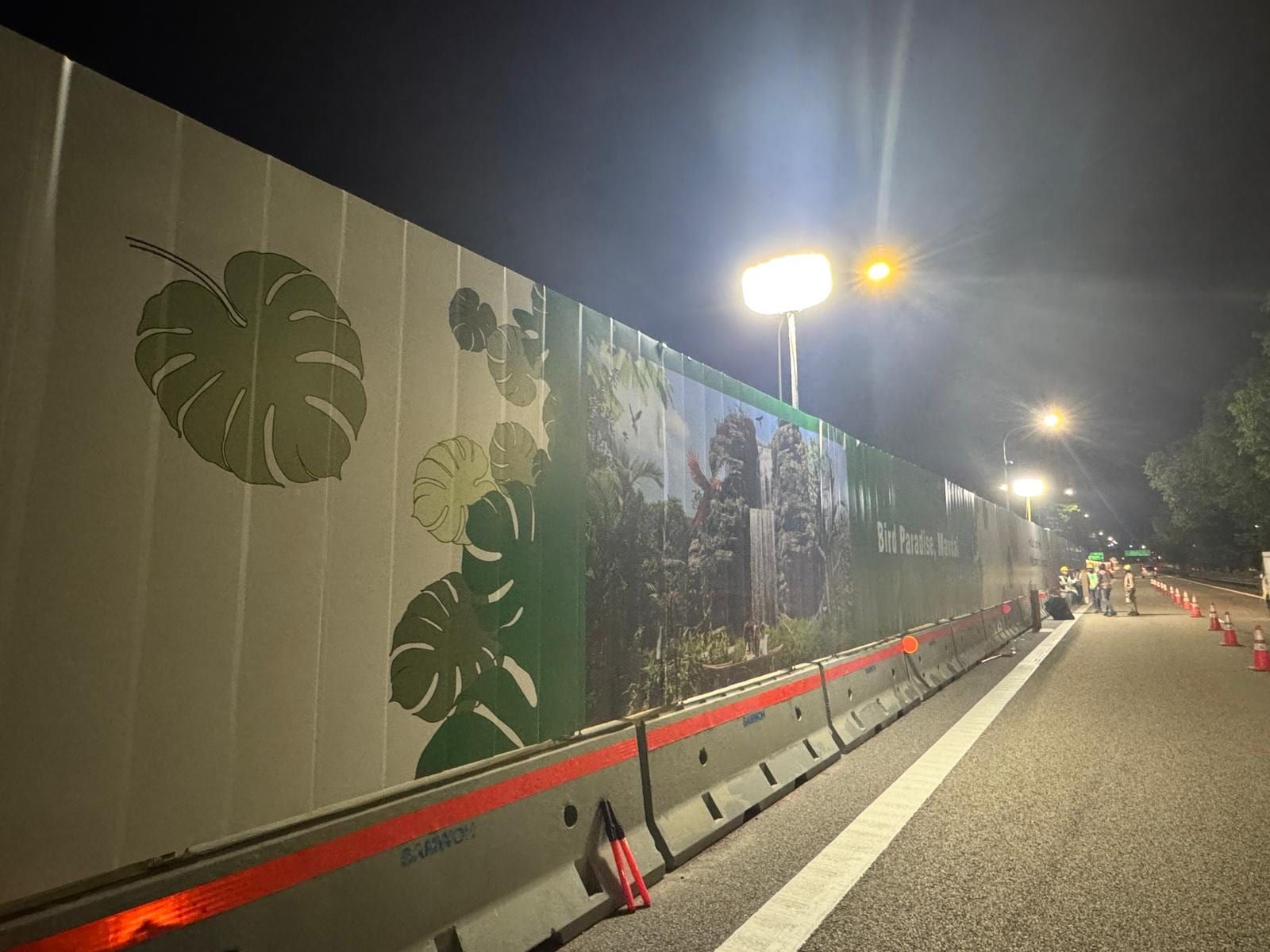Monstera-leaf roadside hoarding at night — Hoarding Sticker Printing by Garrison Productions, Singapore