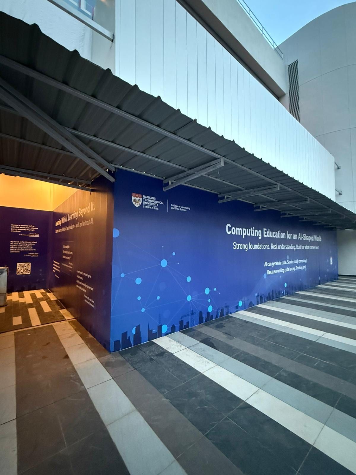 Dark blue school hoarding along a walkway — Hoarding Sticker Printing by Garrison Productions, Singapore