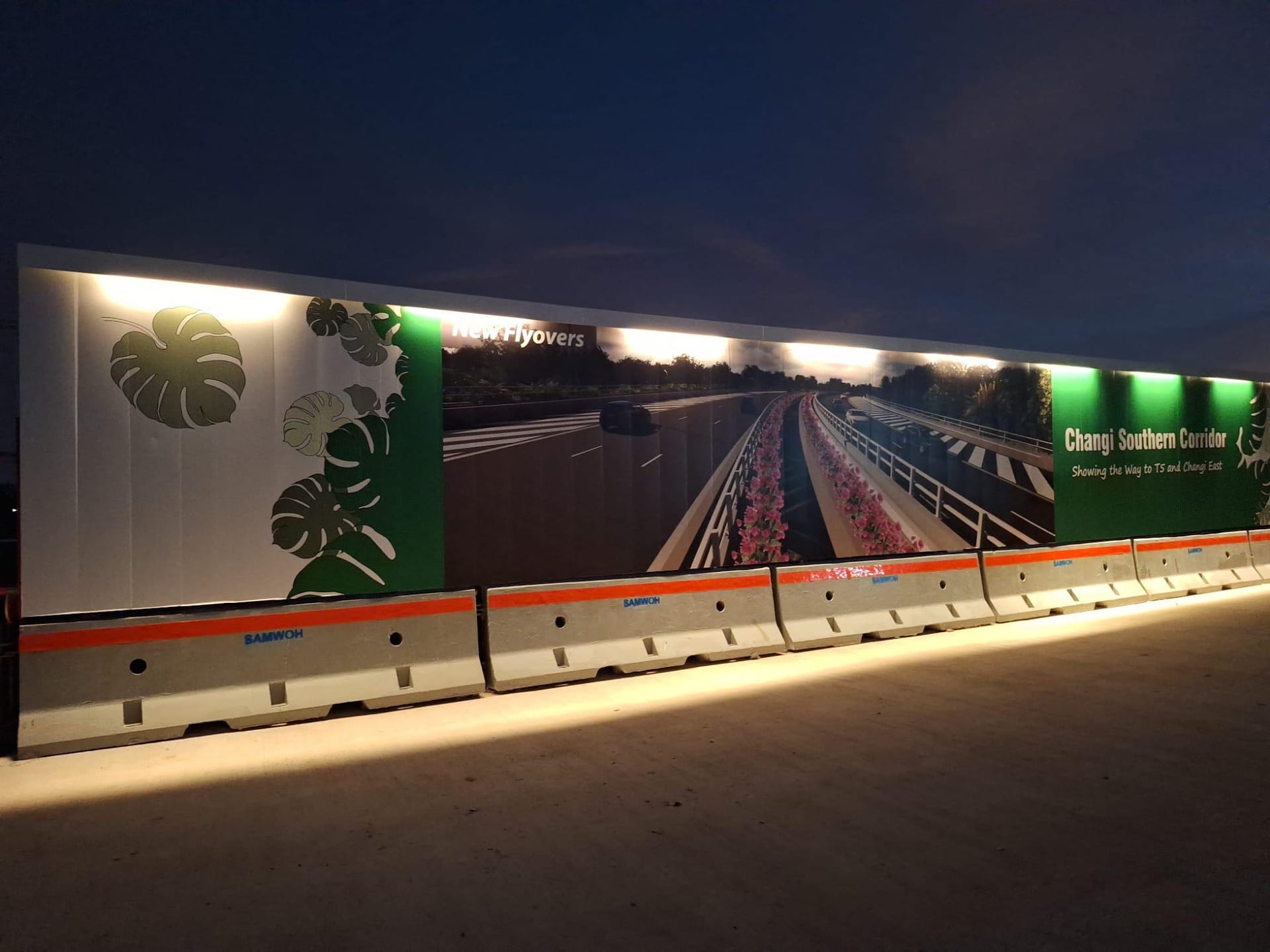 LTA airport road hoarding lit at night — Hoarding Sticker Printing by Garrison Productions, Singapore