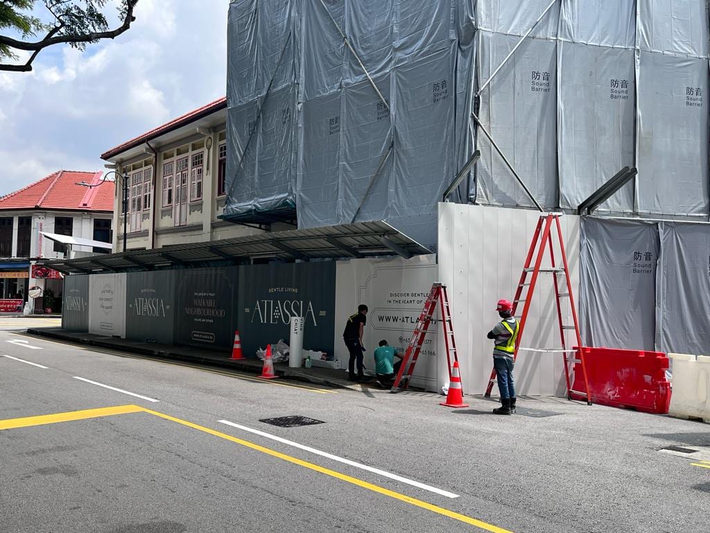 Atlassia shophouse hoarding on installation day — Hoarding Sticker Printing by Garrison Productions, Singapore
