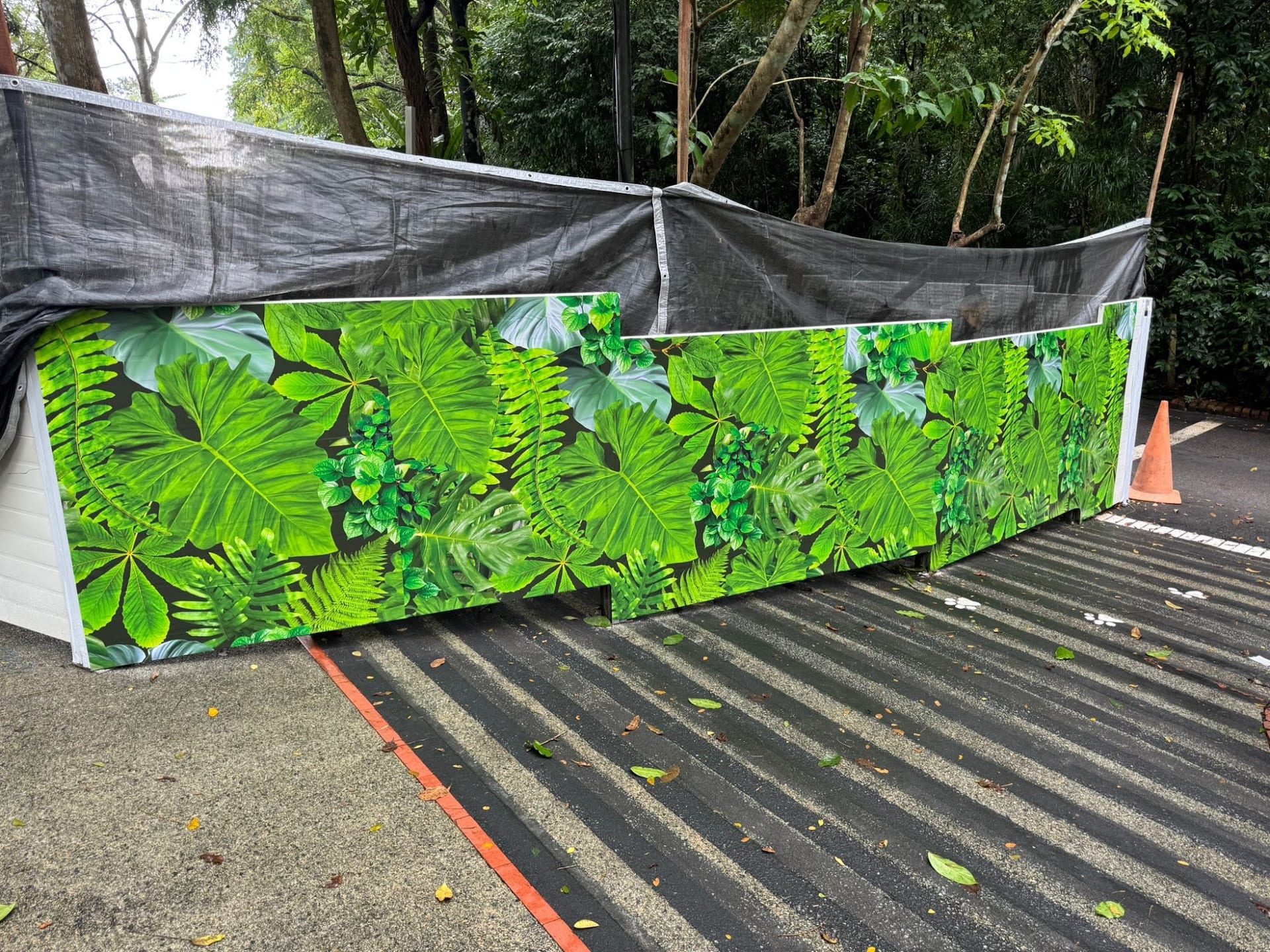 Mandai Wildlife Reserve leaf hoarding beside camouflage netting — Hoarding Sticker Printing by Garrison Productions, Singapore