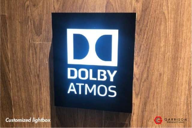 Dolby Atmos custom lightbox on a timber wall — Lightbox Signage by Garrison Productions, Singapore