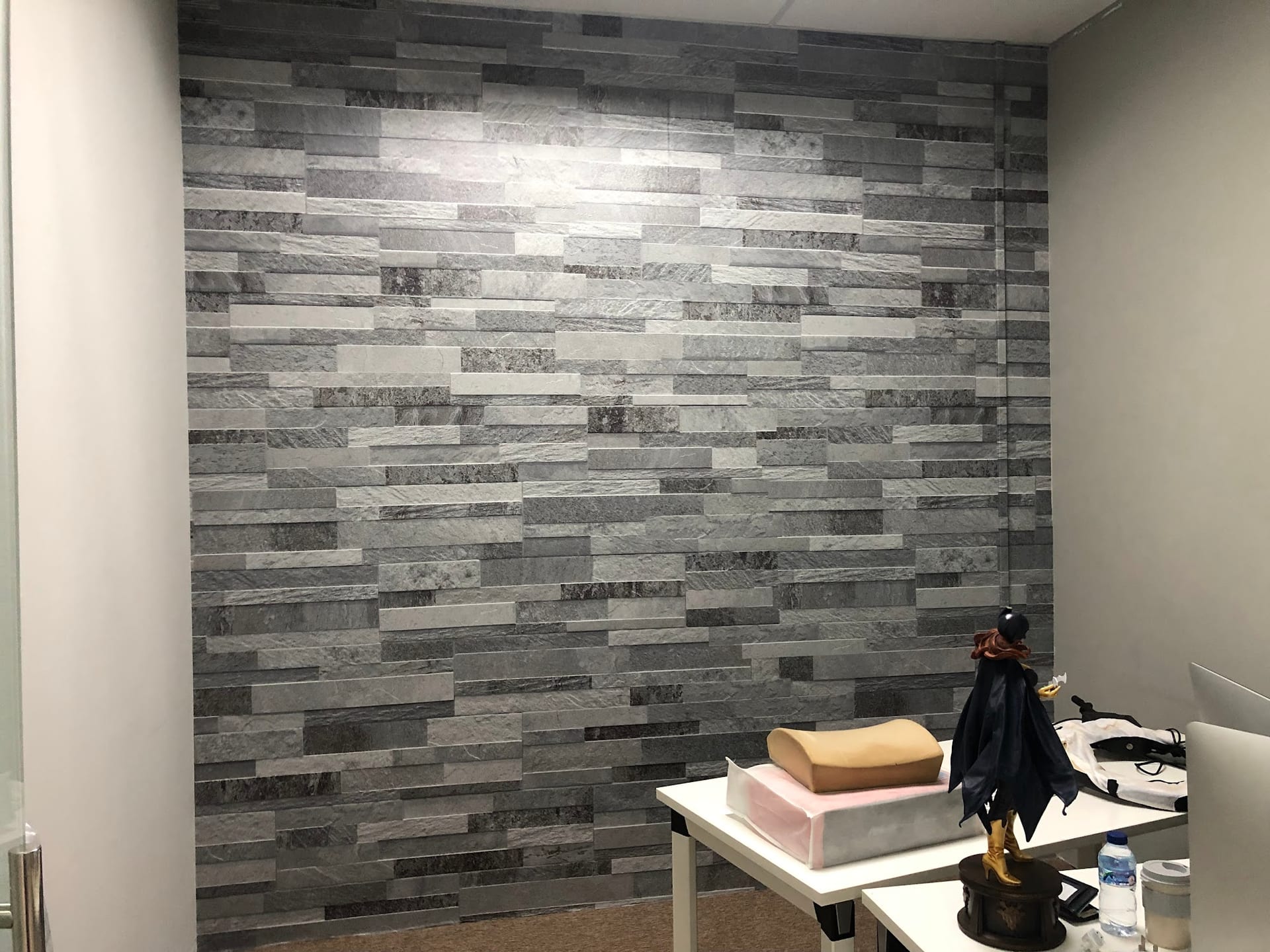 Grey brick-effect wall mural in an office — Wall Mural by Garrison Productions, Singapore