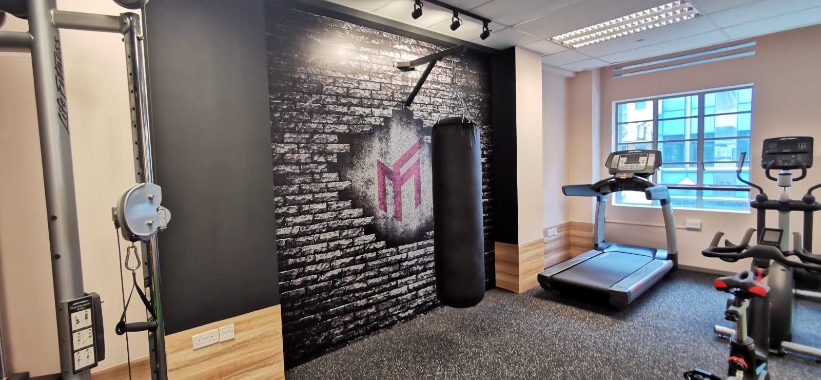Black brick-wall mural in a gym — Wall Mural by Garrison Productions, Singapore
