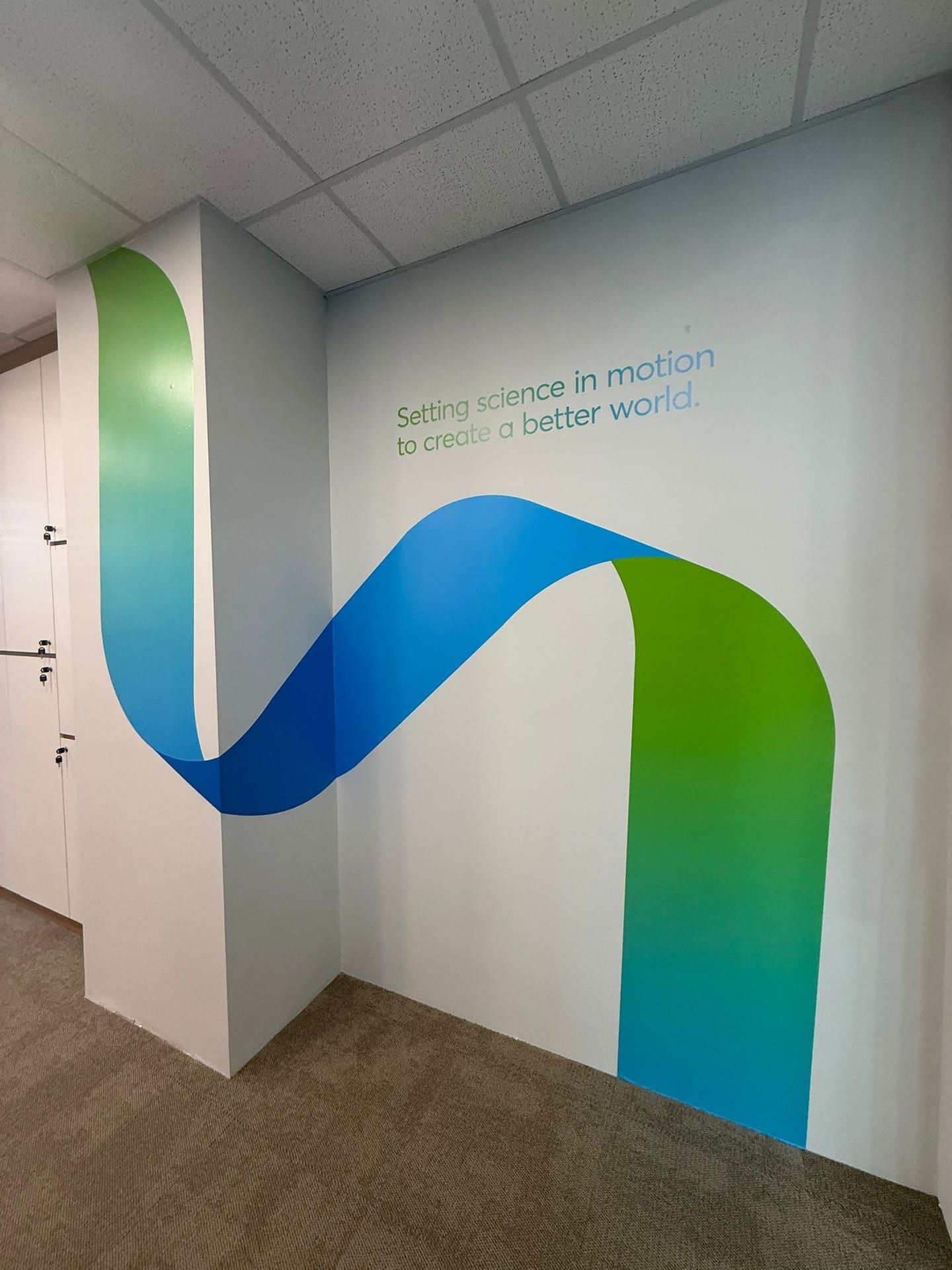 Blue and green ribbon wall graphic in an office corridor — Wall Mural by Garrison Productions, Singapore