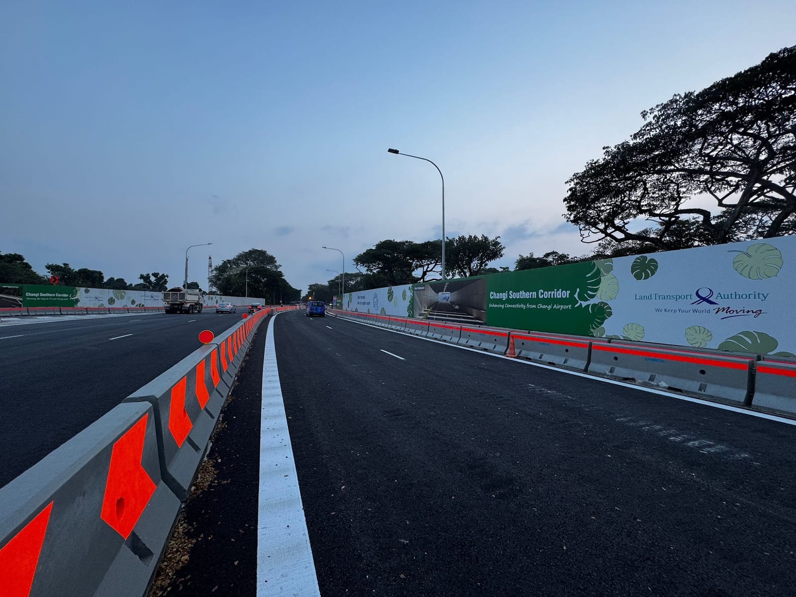 Hoarding stickers on temporary construction hoarding along the road to Changi Airport