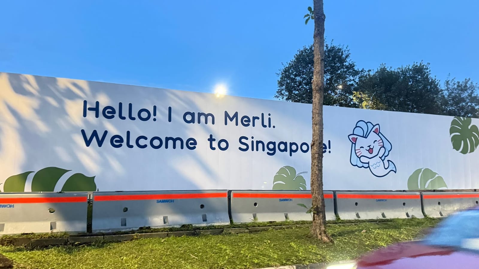 "Hello! I am Merli. Welcome to Singapore!" panel on the airport road construction hoarding